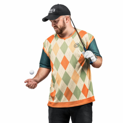 T-shirt for indoor golf designed to look like an argyle vest with undershirt on model bouncing golf ball holding golf club, wearing Carl's Place hat