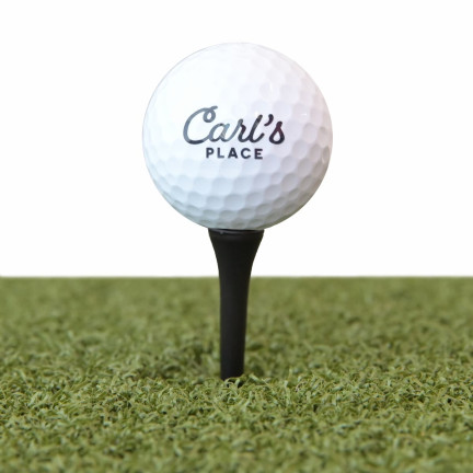 Carl's tee with driver-height golf ball on golf mat