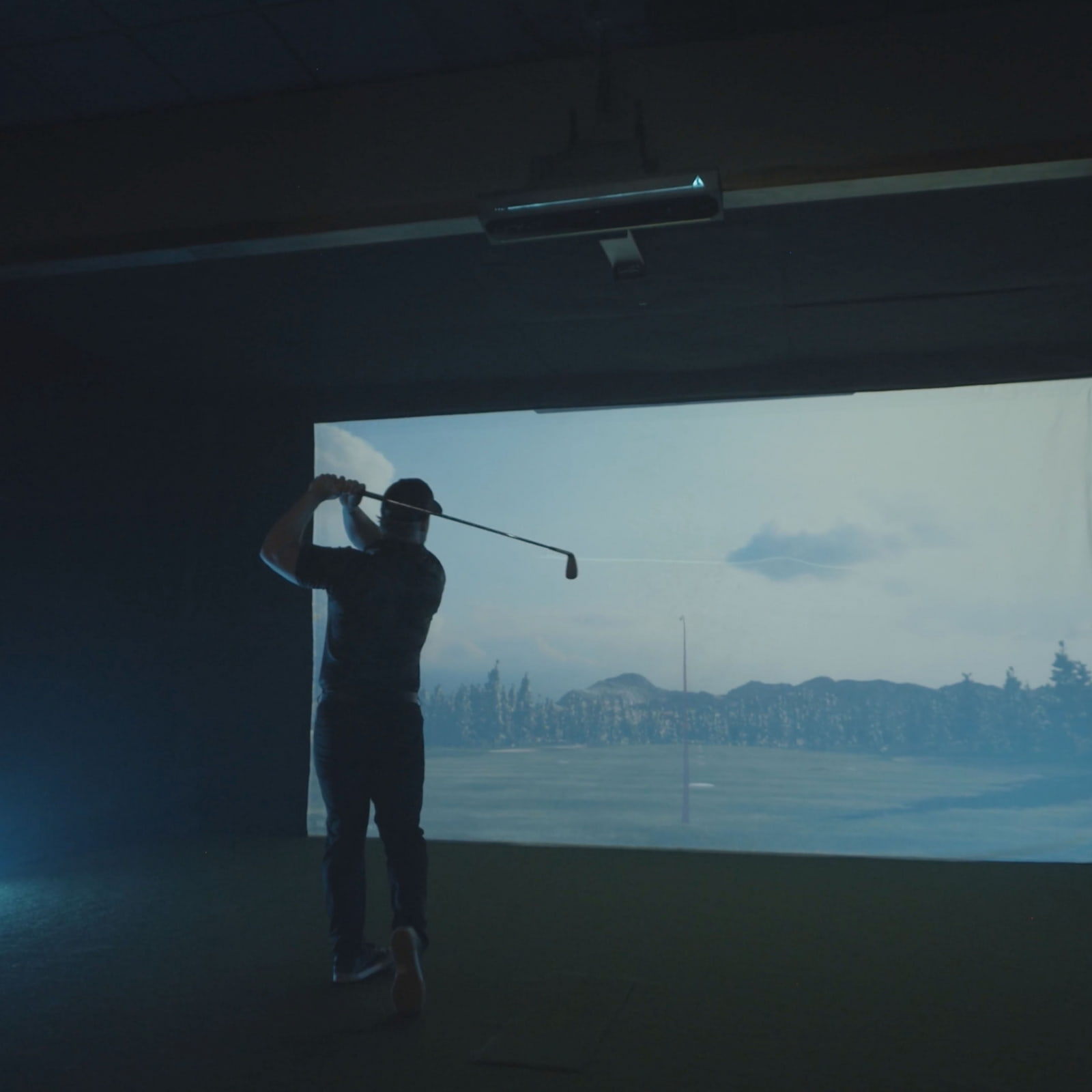 Golfer in Golf Simulator Using APOGEE Launch Monitor from TruGolf