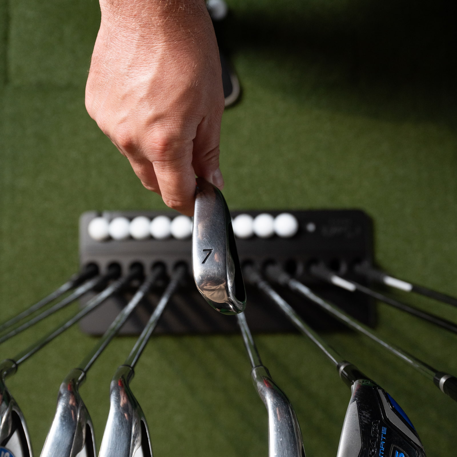 Selecting a 7 iron from Carl golf club holder